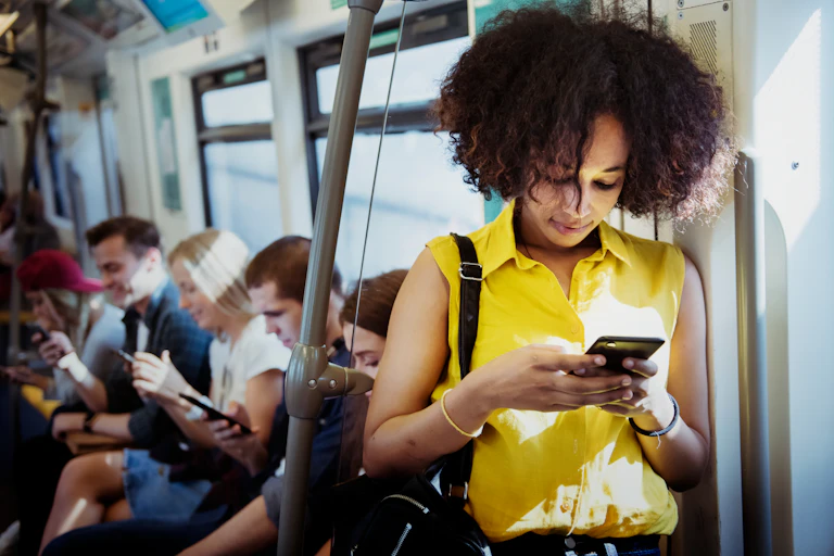 Woman looking at smartphone on train