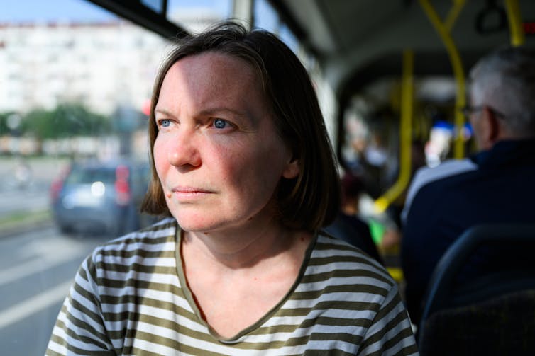 Woman looking serious on bus