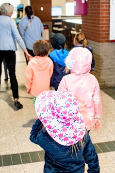 Children seen walking along a path.