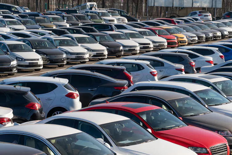 Rows of cars seen in a parking lot