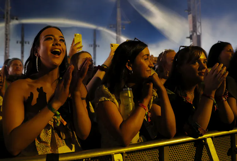 A crowd watches a stage.
