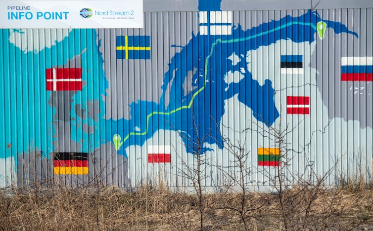 A map with countries flags are seen on a fence