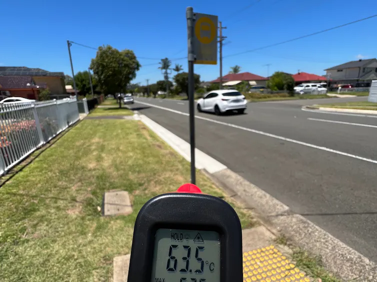 A temperature reading shows 63.5 degrees at a bus stop without any shelter