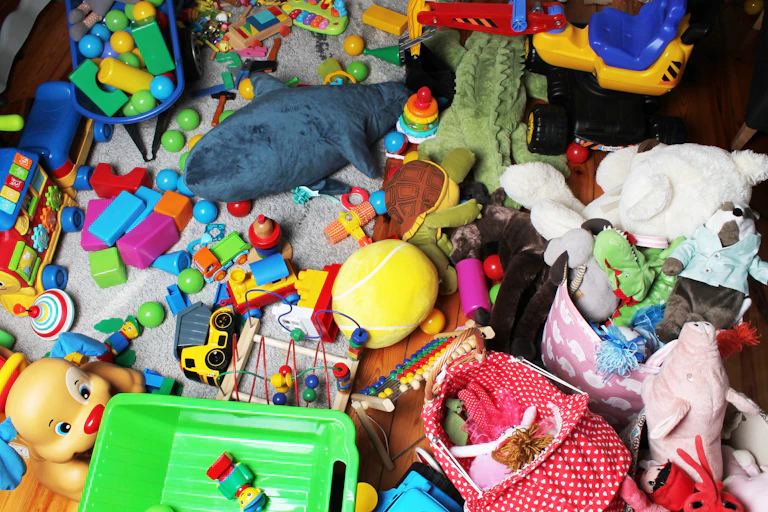 A floor crammed with children's toys, including blocks, soft toys and trucks.