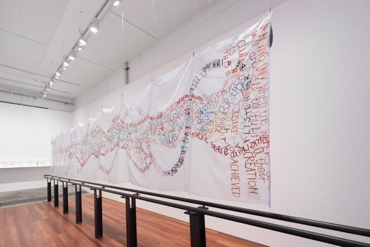 Fabric hanging on a gallery wall.
