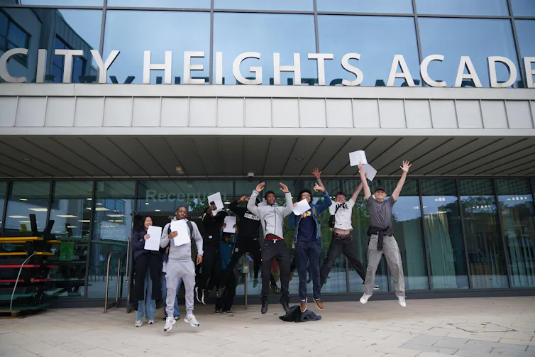 Pupils jumping outside school building