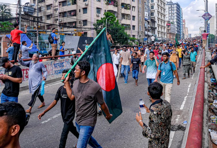 Bangladeshi protestors marching down a road.