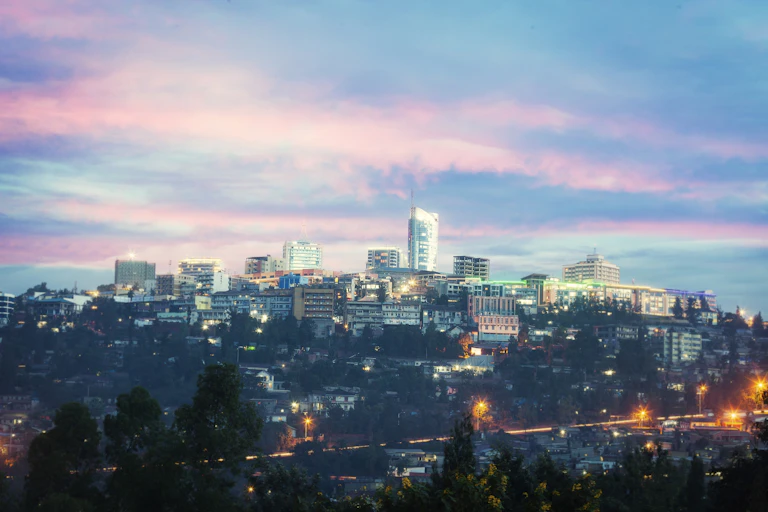View of Kigali business district with offices, towers and residential homes, at sunset.
