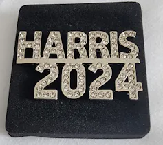A rhinestone-encrusted pin reading 'Harris 2024.'