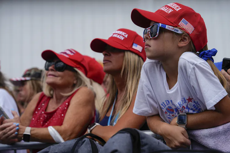 Supporters watch Republican presidential candidate and former President Donald Trump's speech during a campaign rally
