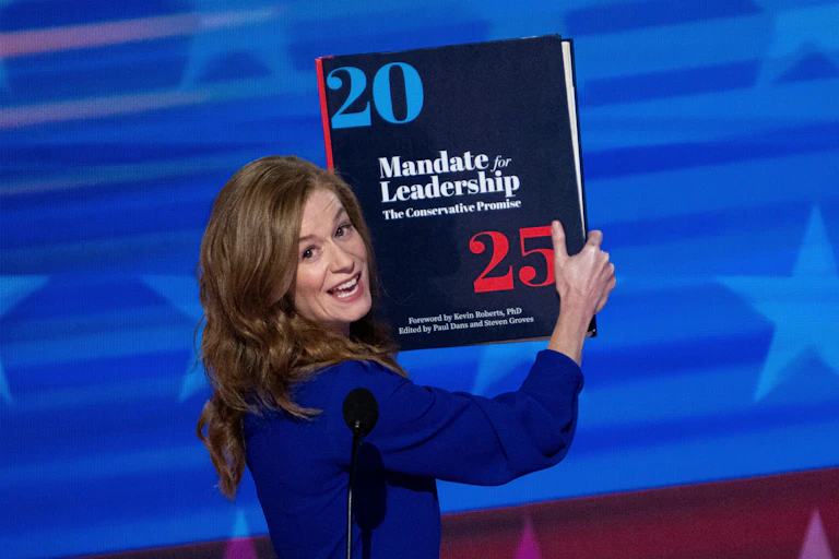 Michigan State Senator Mallory McMorrow holds up a Project 2025 book as she speaks during the 2024 Democratic National Convention in Chicago.