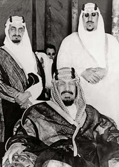 King Abdul Aziz sat in front of Prince Faisal and Prince Saud.
