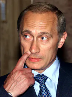 A man scratches his lip