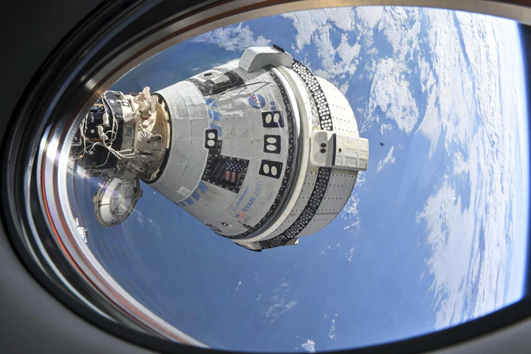 A conical space capsule seen through a rounded window.