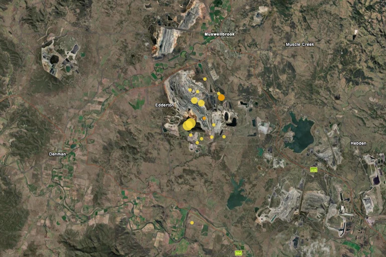 A satellite map with yellow and orange dots indicating earthquakes.