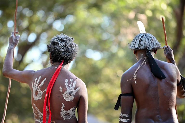 The backs of two Aboriginal man with traditional body paint