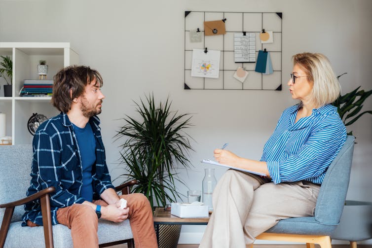 A man talking to a female counsellor or psychologist.