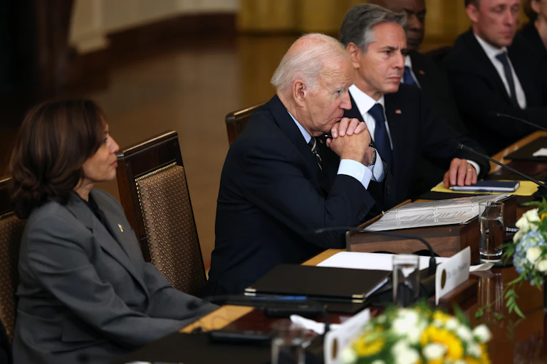 Kamala Harris, Joe Biden and Antony Blinken sit at a conference table.