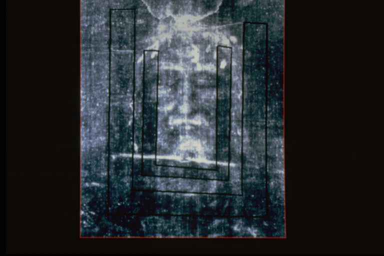 A negative showing a blurred image of a man with his eyes closed.