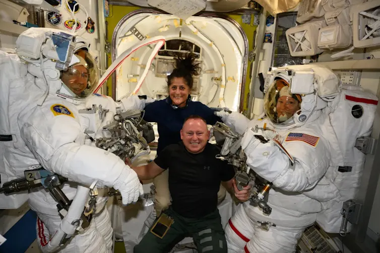 Sunita Williams and Butch Wilmore (centre) pose with astronauts Michael Barratt (left) and Tracy Dyson (right).
