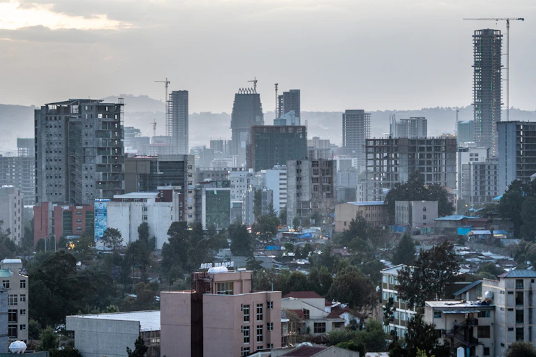 View of high-rise buildings under construction, with cranes in the background