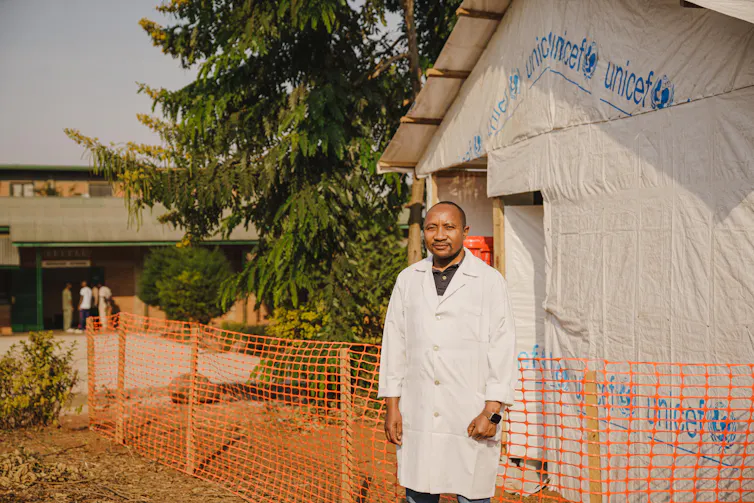 Doctor in fromt of tent