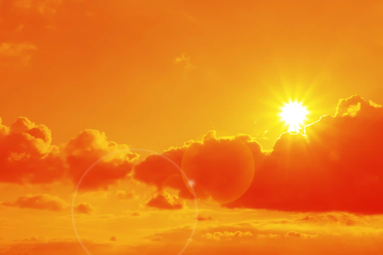Sun and clouds in an orange sky.