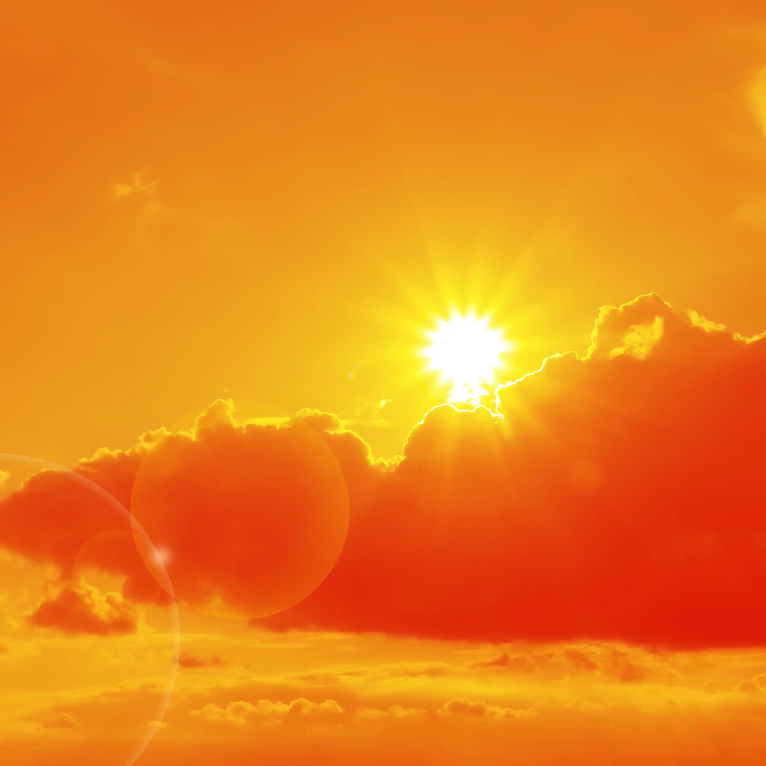 Sun and clouds in an orange sky.