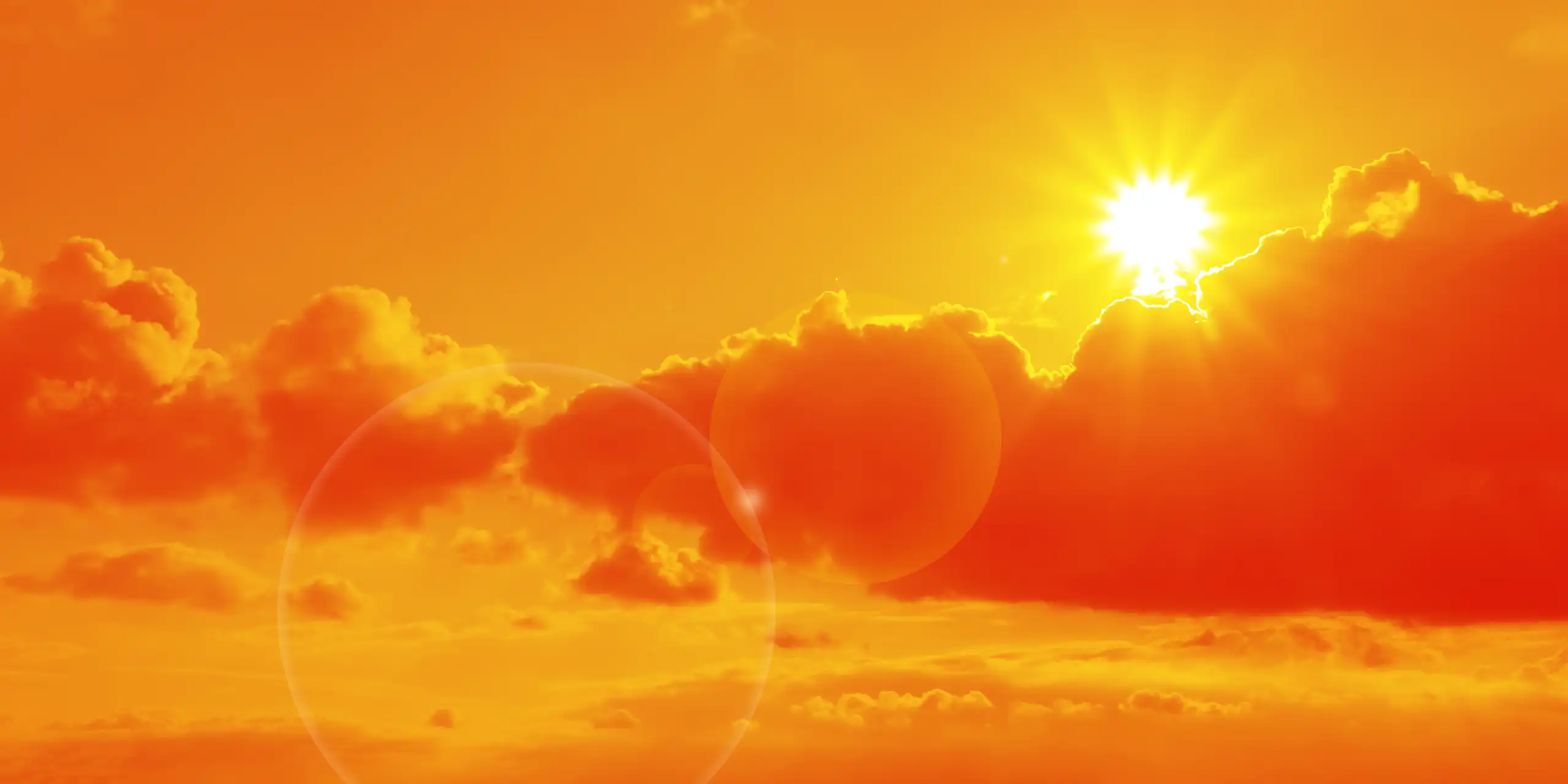 Sun and clouds in an orange sky.