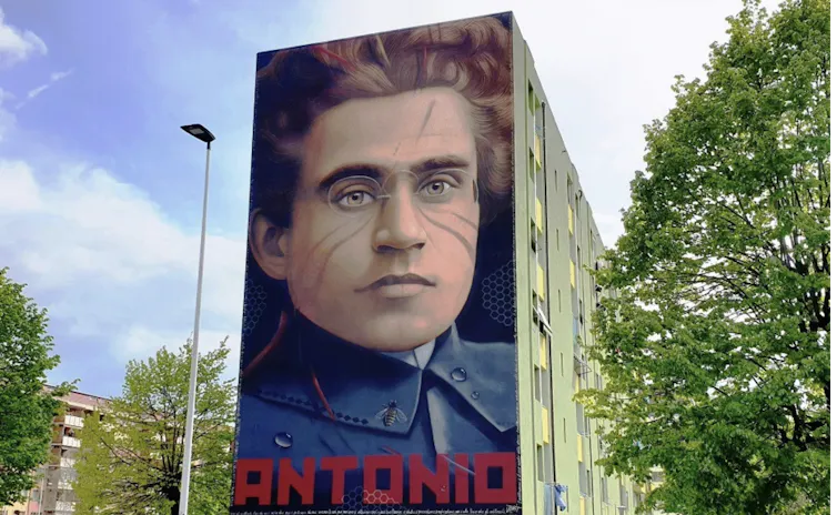 A man's face painted on the side of an apartment building
