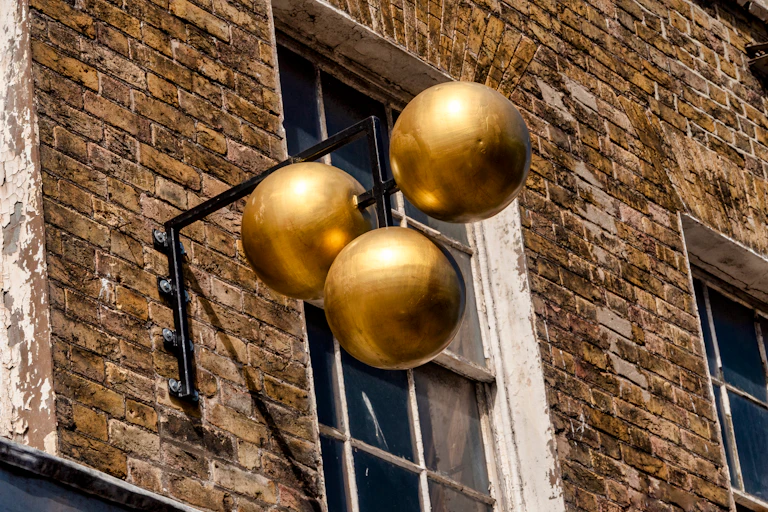 traditional pawnbroker sign outside the shop featuring three gold balls