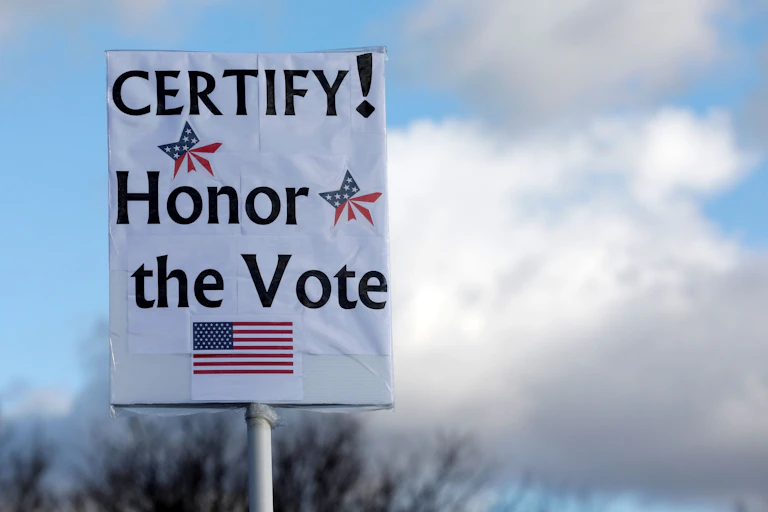 A sign saying 'CERTIFY! Honor the Vote'