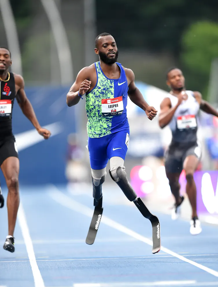 Athlete with two running blades competing in an event.