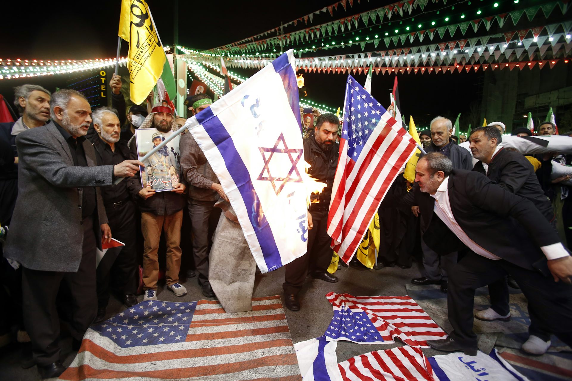 Iranians burn Israel and US flags.
