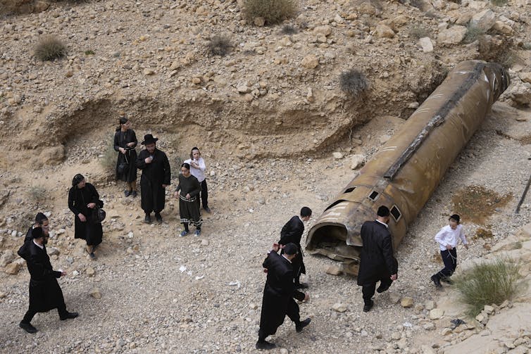 Israelis inspecting the debris of an intercepted Iranian missile.