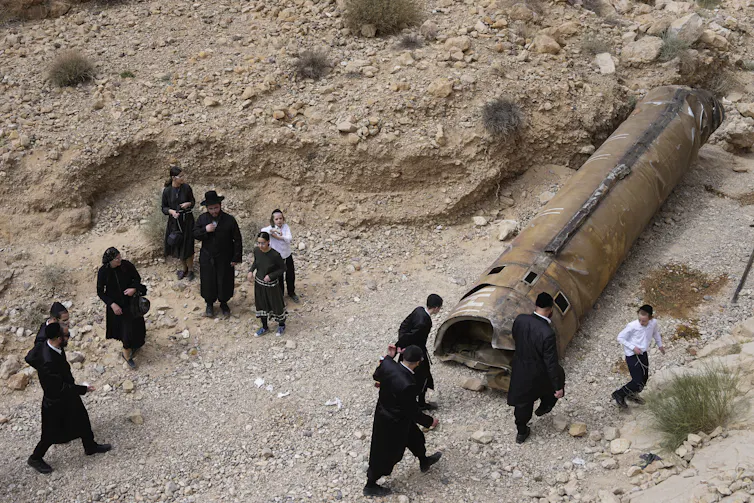 Israelis inspecting the debris of an intercepted Iranian missile.