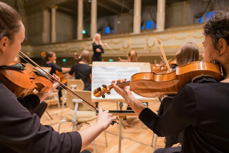Two violinists in an orchestra
