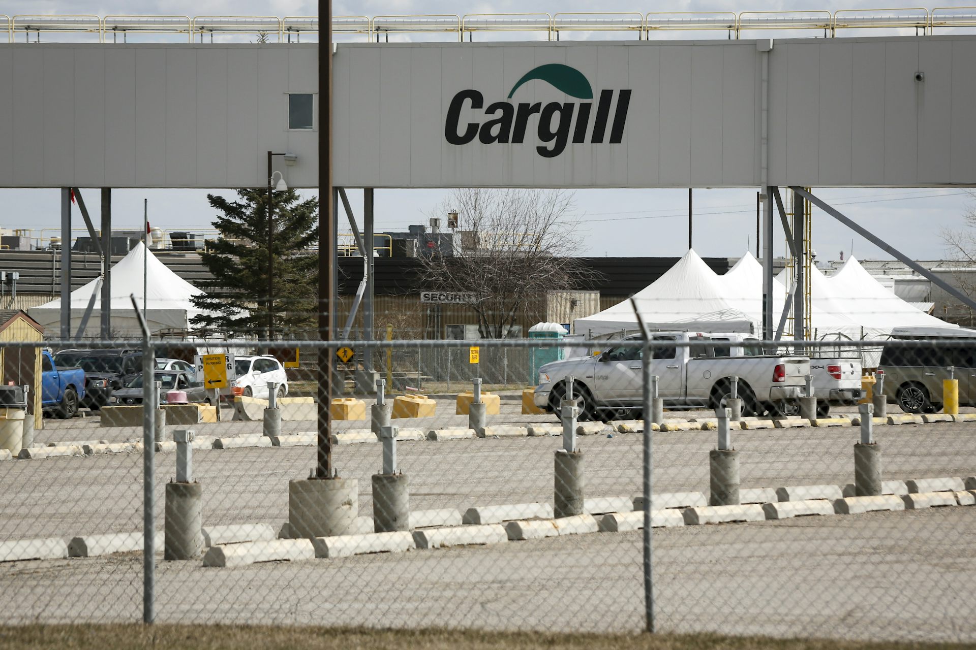 A sign that says Cargill is seen above the parking lot of a beef processing facility