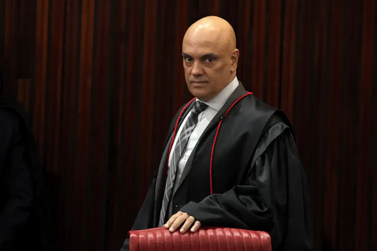Man in black legal robes in court.