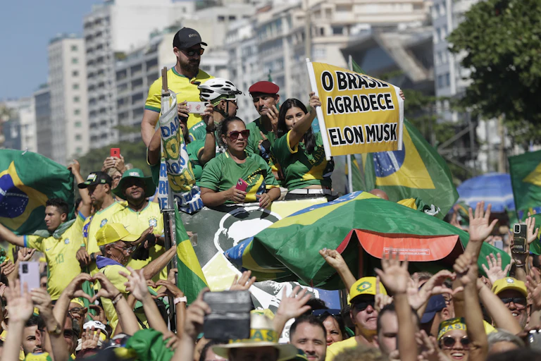 People in Brazil protesting holding sign in support of Elon Musk