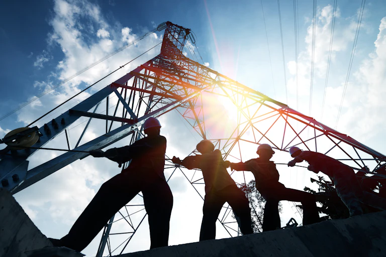 silhouette of workers on electricity project