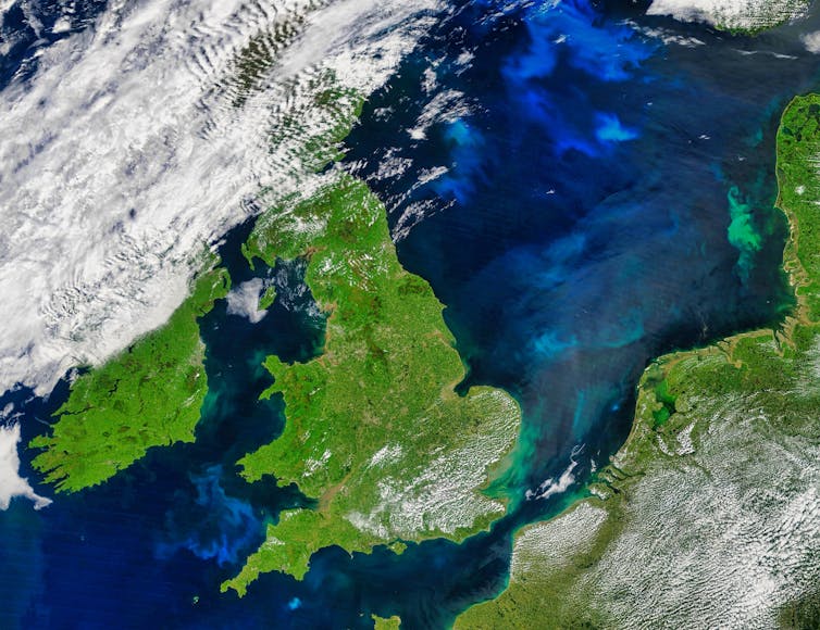 A satellite map of the UK with plankton blooms in coastal waters.