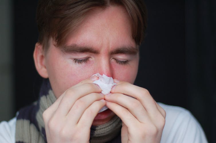 Man blows nose