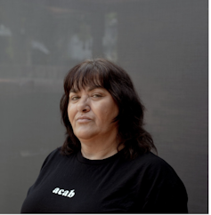 A woman wearing a black t-shirt.