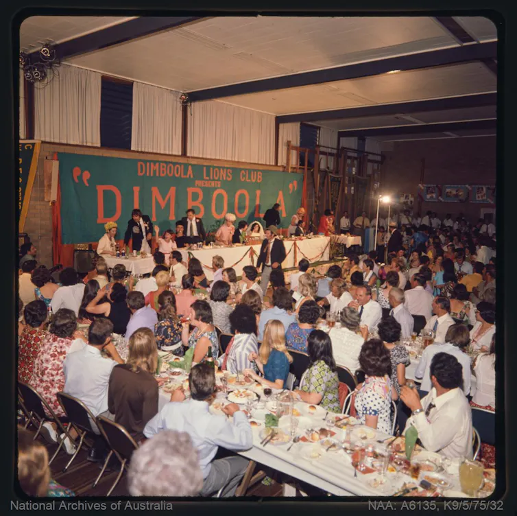 A theatre audience looking like a wedding reception.