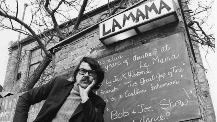 Jack in front of the chalkboard at La Mama.