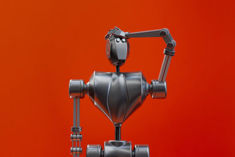 Un robot en métal se tape le front comme s'il avait oublié quelque chose, sur un fond rouge.