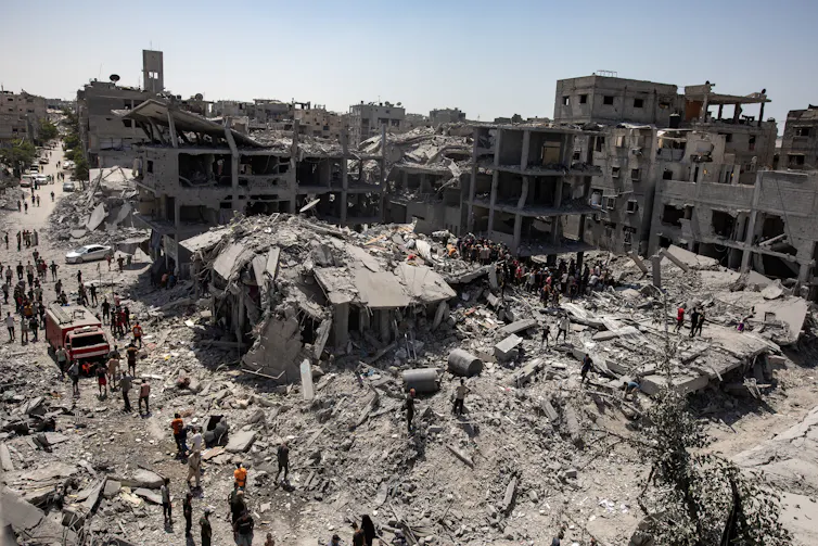 Palestinians search for survivors under the rubble after an Israeli airstrike.