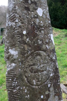 An ancient stone with carvings.