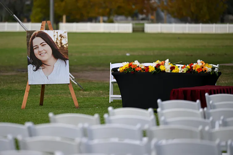 A photograph of a young woman at a funeral service.